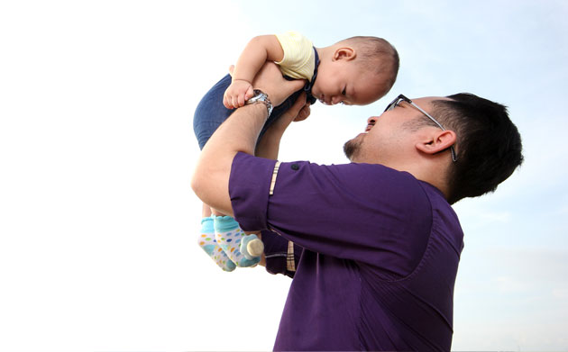 Father playing with young son